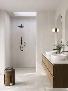 a bathroom with two sinks and a shower