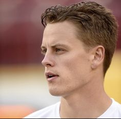 a close up of a person wearing a white shirt and looking off to the side