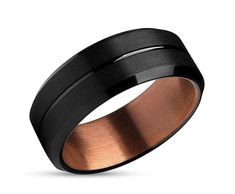 a black and rose gold wedding ring with an inlay design on the inside of it