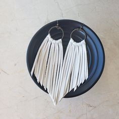 "Long Fringe Leather Earrings- Leather Fringe Earring - Boho Earrings - Fringe Earrings - Tassel Earrings - Western Jewelry- Western Earrings - Gift This listing is for a handmade Genuine Leather Fringe Earrings with nickel free ear wires. Colors: white color, super soft genuine leather * Leather measures approx 4 inches, with hook and circle charm approx 5 inches All earrings are handmade by yours truly! I have multiple sizes, shapes, patterns and colors available! Special requests are always w White Fringe Tassel Earrings For Festivals, White Bohemian Fringe Earrings, White Dangle Tassel Earrings For Festivals, White Tassel Jewelry For Festival, Festival White Jewelry With Tassels, Festival White Tassel Jewelry, White Fringe Tassel Earrings As Gift, White Adjustable Tassel Earrings For Festivals, Adjustable White Tassel Earrings For Festivals