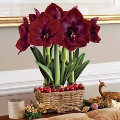 a basket filled with red flowers sitting on top of a table