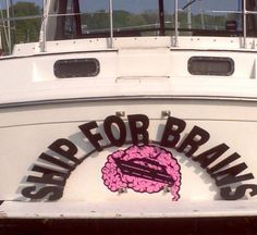 a white boat with the words ship for brains on it's side and a pink brain in the center