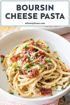 a white bowl filled with pasta and bacon on top of a red checkered table cloth