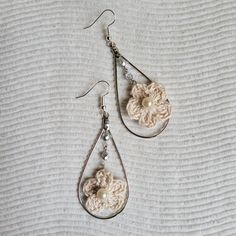 Thought up, created, and assembled on a rainy day. This romantic and delicate dangle earring is just beautiful.  Crochet flower using thread yarn. Czech fire polished glass beads. Center of flower is a plastic pearl. Ear hooks are stainless steel with silver plating. Handmade Adjustable Teardrop Flower Earrings, Elegant Adjustable Flower Shaped Beaded Earrings, Handmade Elegant Flower Teardrop Earrings, Handmade Cream Flower Earrings, Handmade Cream Flower Earrings For Gift, Elegant Handmade Flower Teardrop Earrings, Elegant Handmade Flower Shaped Teardrop Earrings, Kailua Kona, Thread & Yarn