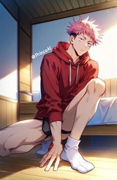 a man with pink hair sitting on the floor in front of a bed wearing white socks