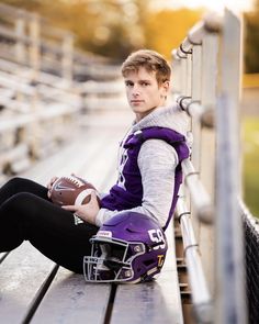 a young man sitting on the bleachers holding a football