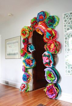 an arch made out of colorful paper flowers