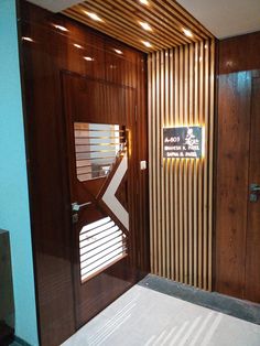 the entrance to an office building with wooden walls and doors, along with a white bed