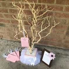 there is a tree that has been decorated with pink and white decorations on it, along with other items