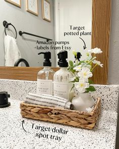 a bathroom counter with soap, lotion and flowers in a wicker basket on it