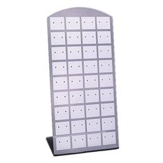 a white display board with holes in the middle and two rows of dots on it