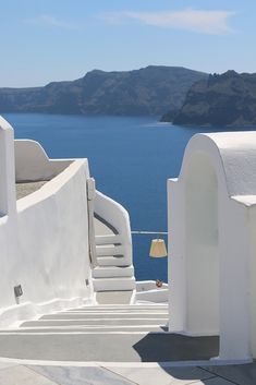 a white building with steps leading to the water