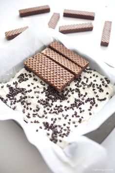 chocolate wafers and white frosting in a baking dish