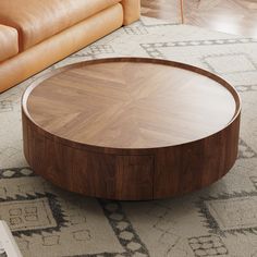 a round wooden table sitting on top of a rug