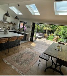 an open kitchen and dining room with skylights