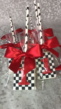 four candles are wrapped in cellophane and tied with red ribbon