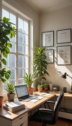 a laptop computer sitting on top of a wooden desk next to a potted plant