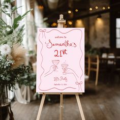 a sign that is on top of a easel in front of a table with flowers