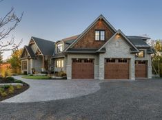 a large house with two garages in the front and one on the other side