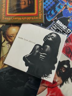 various album covers are stacked on top of each other, including one with a woman's face