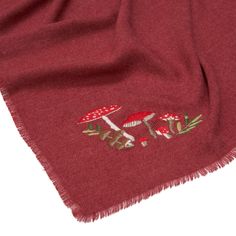 Wrap yourself in the enchanting warmth of our embroidered mushroom burgundy pashmina scarf. The vibrant, whimsical mushroom design adds a touch of magic and charm, perfect for brightening up your winter wardrobe. Made from soft, recycled materials, this scarf provides both comfort and a splash of color for cosy, seasonal outings. Crafted from 80% acrylic and 20% viscose, this scarf offers both durability and softness. To maintain its vibrant colors and soft texture, machine wash at 30°C (delicat Red Embroidered Shawl For Winter, Red Embroidered Winter Shawl, Red Embroidered Pashmina Shawl, Luxury Embroidered Red Pashmina Shawl, Red Embroidered Pashmina Scarves, Bohemian Red Pashmina Scarf, Luxury Traditional Red Scarf, Fable England, Magical Mushroom