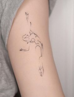 a woman's arm with a tattoo on it that has a line drawing of a person doing a handstand