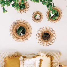 three decorative mirrors on the wall above a couch