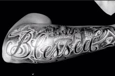 a man with a tattoo on his arm that reads blessing and has the word jesus written in cursive font