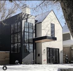 a large white and black house in the snow