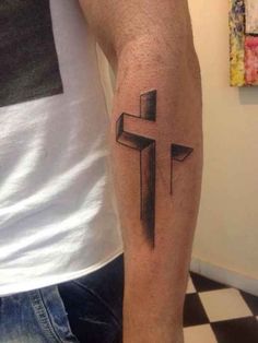 a man with a cross tattoo on his arm