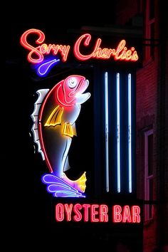 a neon sign that says sorry charles's oyster bar on the side of a building