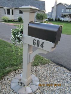 a mailbox with the number 604 on it is in front of a house