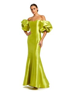 a woman in a lime green gown with her hands on her hips, posing for the camera