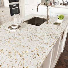 a white counter top with gold speckles in a kitchen