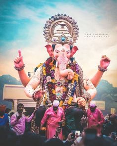 an elephant statue with people around it