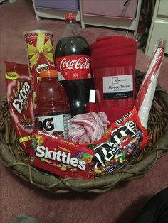 a basket filled with snacks and drinks on the floor