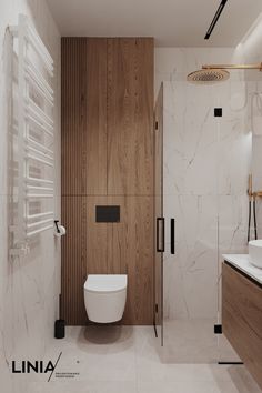 a bathroom with a toilet, sink and shower in it's center wall next to a wooden cabinet