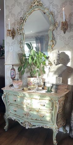 an antique dresser and mirror in a room