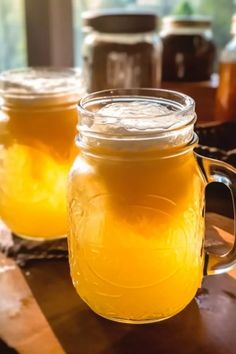 two jars filled with liquid sitting on top of a table