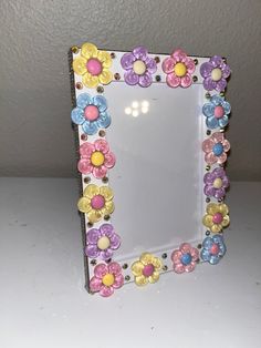 a small mirror with flowers painted on it