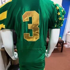 the back of a green jersey with gold stars and number 3 on it's chest