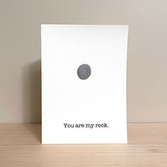 a card with the words you are my rock on it and a black dot in the middle