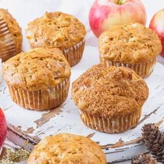 apples and muffins sitting on top of a table