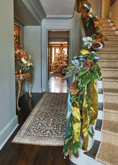 a staircase decorated with christmas decorations and greenery