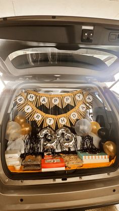 the trunk of a car is filled with decorations