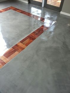 an empty room with wood flooring and glass doors