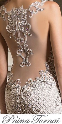 the back of a woman's dress with sequins and beads on it