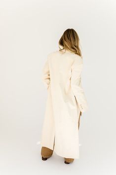 a fresh take on the oversized blazer, this cream trench coat is a must-have for business casual baddies. it has a relaxed longline silhouette, luxe working buttons, + is made with a thick cotton material (so it will actually keep you warm). the perfect spring // winter coat to elevate your casual fits or embellish your formal ones. natural // lapel collar, buttons, pockets, cuffed sleeves, corduroy paired with our charlotte wrap top + kenny cargo pants + hardi slingback penny loafers model is 5' Cream Trench Coat, Oversized Blazer, Penny Loafers, Wrap Top, Lapel Collar, Cuff Sleeves, Casual Fits, Long A Line, Winter Coat