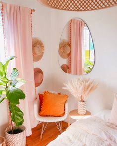 a bed room with a neatly made bed and two round mirrors on the wall above it