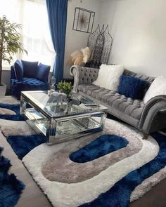 a living room filled with furniture and blue rugs